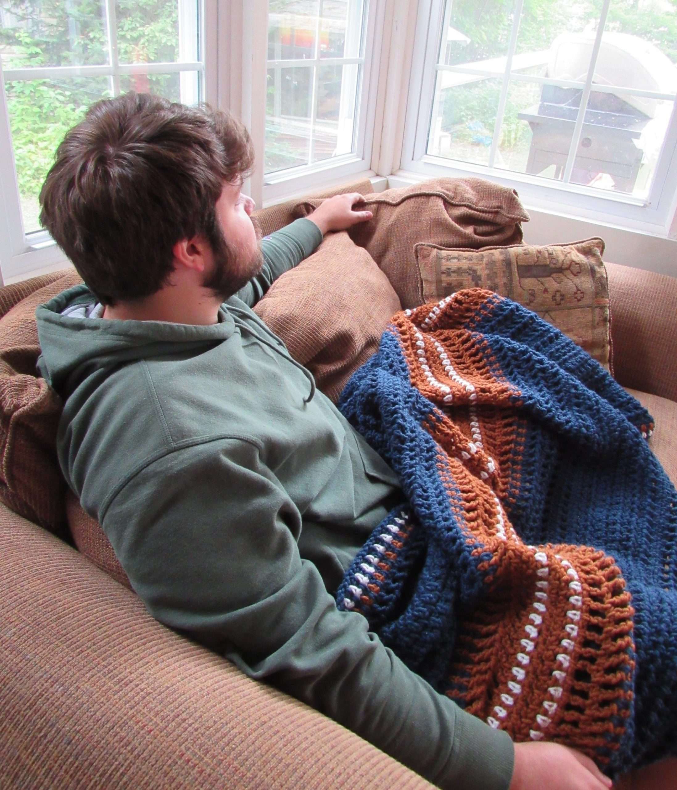 Snuggled Under a Crochet Blanket