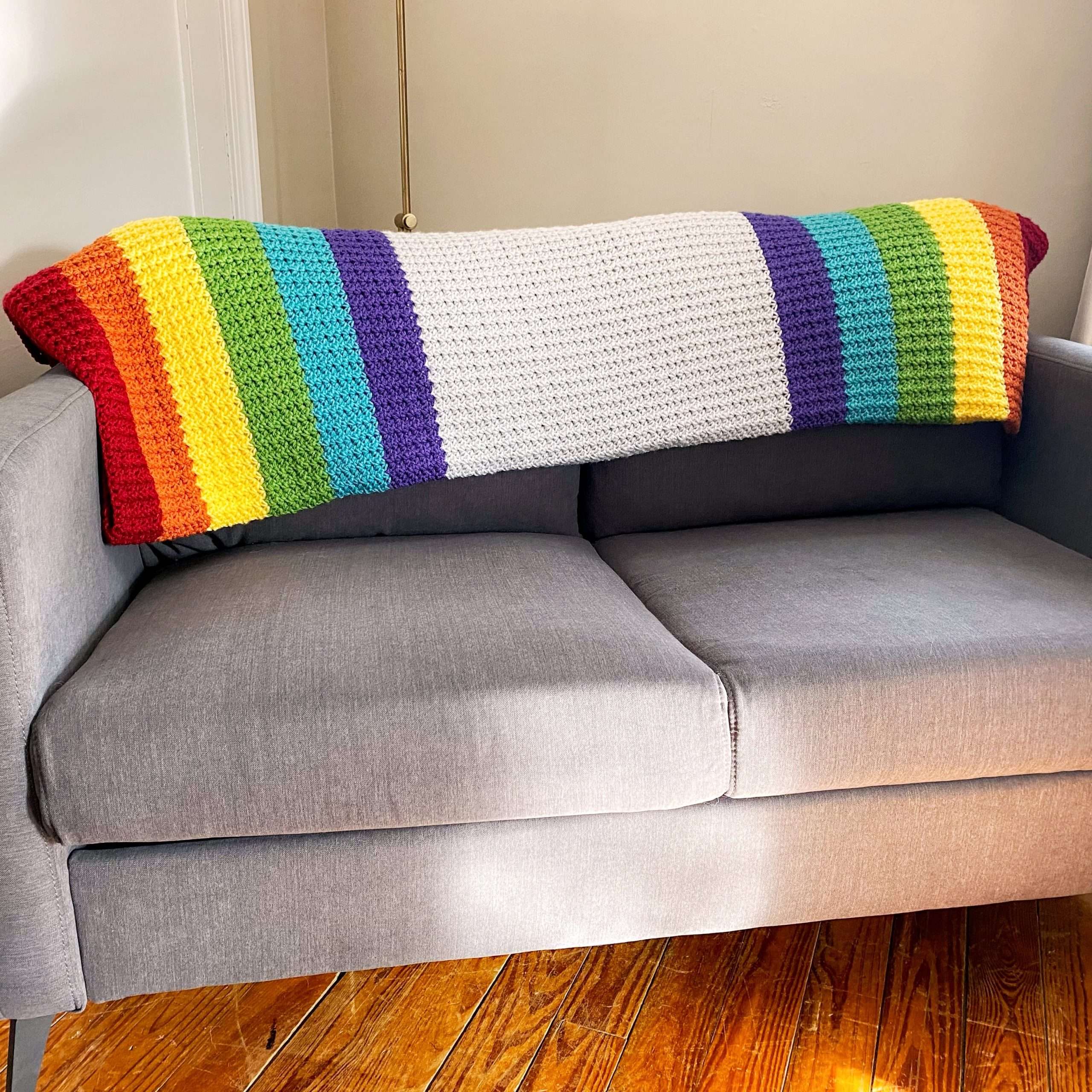 Spider Stitch Single Crochet Rainbow Blanket on Couch